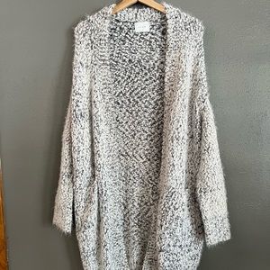 Oversized fuzzy black and white knee length sweater in size small.